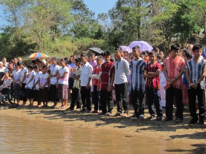 The candidates all lined up to be baptized. Each one has picked their favorite Bible verse to be read before they enter into the water.