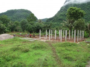 The new site for the boy's dorm. Here they are putting in the cement posts for the first floor.