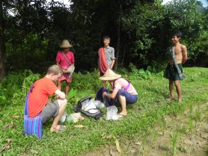 As we were walking through rice paddies, a man caught our attention. He and his family live in a small village of 5 huts, and he needed some malaria medicine for 40 year old man. So we get the packs down and Erick and I look through the bags to find the medicine.