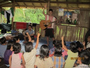 We arrived at our home base village around mid afternoon and started a branch sabbath school for the village children. Here some of our students are teaching them God songs and telling them Bible stories. The children were very receptive and enjoyed it very much.