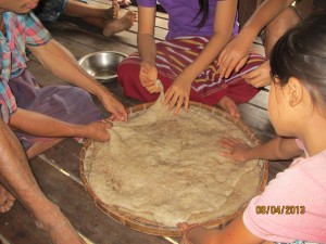 We finally arrive to our home base village were the students are making a sticky rice treat. They cook the sticky rice, then they pound it with sesame seed till it is like sticky dough, then they flatten is on bamboo trays to dry, then they break it into small pieces and deep fat fry them.