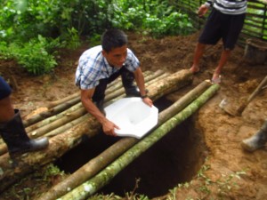 Trying to make a "floor" for the squat pot toilet. They used bamboo poles first, and then they rock and mud on top of the bamboo poles to make the "floor". Amazing how they build when they don't have modern conviences.