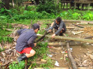 Sawing bamboo poles for the corner posts.