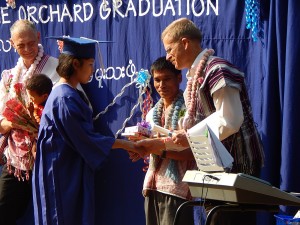 Graduates receiving their diplomas and other gifts.
